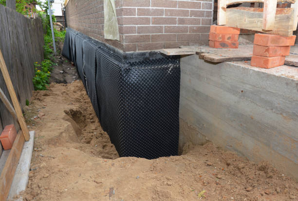 SJ Waterproofing Pros technician performing targeted Exterior Waterproofing assessment in Laceys Spring, AL